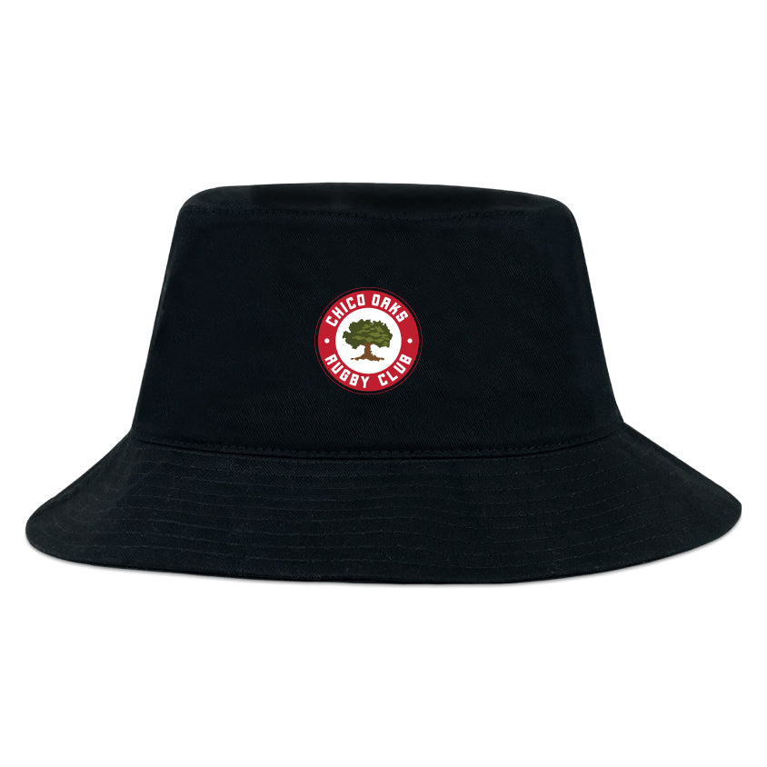 The EMB S&S Activewear Chico Oaks Crusher Bucket Cap is a black cotton twill bucket hat with a front circular "Chico Oaks Rugby Club" logo featuring a tree, combining stylish sun protection with club pride.