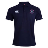 The Clover Middle Girls Waimak Polo by EMB Canterbury is a navy blue short-sleeved shirt with a white Canterbury logo on the right chest and a "Clover Rugby" emblem on the left chest.