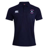 The Clover Middle Girls Waimak Polo by EMB Canterbury is a navy blue short-sleeved shirt with a white Canterbury logo on the right chest and a "Clover Rugby" emblem on the left chest.