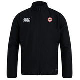 The Chico Oaks Club Track Jacket by EMB Canterbury is a lightweight black jacket featuring the Canterbury logo on the left chest, a round emblem on the right, zipper closure, and high collar for quick drying comfort.
