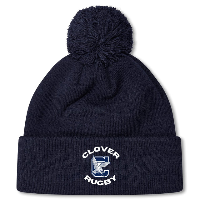 The Clover Middle School Pom Pom Beanie by EMB Canterbury is a navy blue knit hat with a pom-pom and features a "CLOVER RUGBY" logo with a large C and horse’s head on the front cuff.