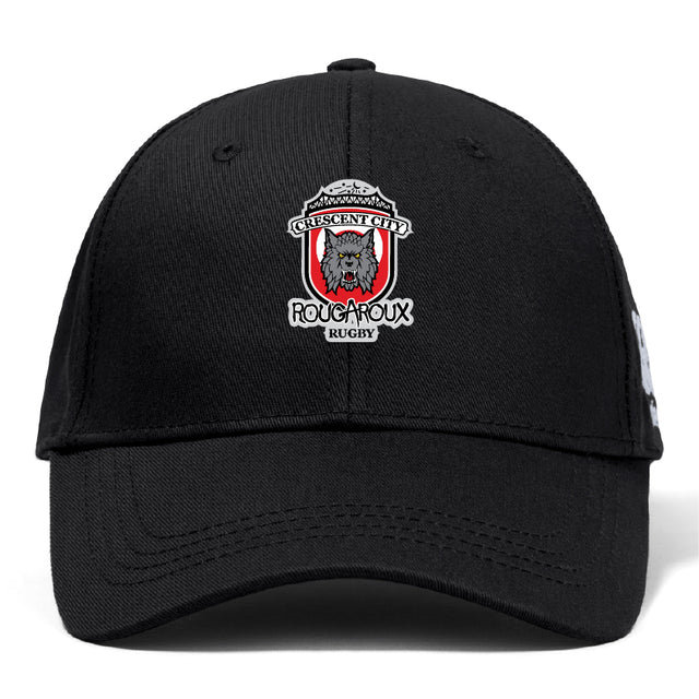 The Crescent City Rougaroux Flexfit Drill Cap by Canterbury from EMB Canterbury is a black baseball hat featuring a wolf logo on the front and a stylish curved brim.