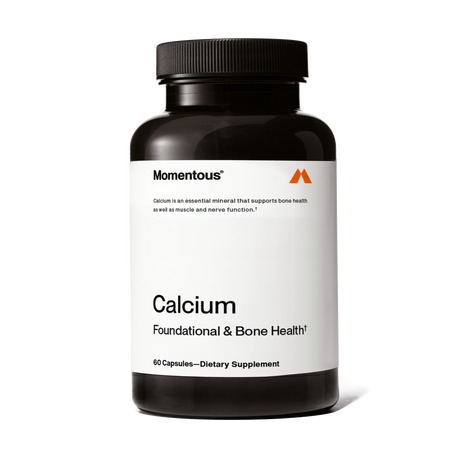 Momentous Calcium is a dietary supplement in a black bottle labeled "Calcium Foundational & Bone Health," containing 60 capsules of absorbable calcium to support bone strength.