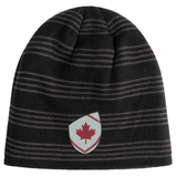 The EMB Canterbury Canada Shield Beanie features black and grey stripes and a shield patch with a red maple leaf—ideal for rugby supporters.