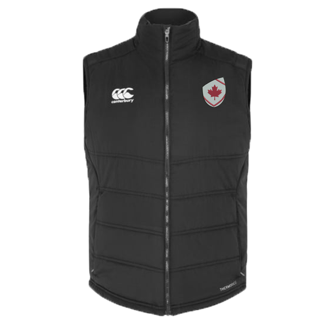 The Canterbury Canada Shield Core Gilet by EMB Canterbury is a black zip-up puffer vest with Thermoreg insulation, featuring a Canterbury logo on the right chest and a maple leaf shield emblem on the left chest.