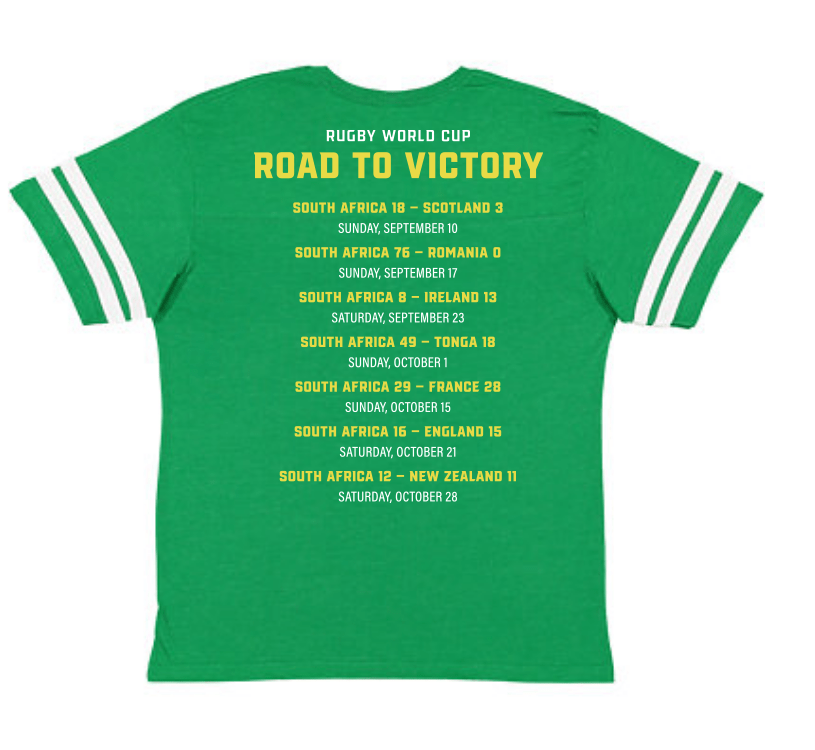 A green South Africa RWC 23 Champions Football Tee that says road to victory, produced by WRS LAT.