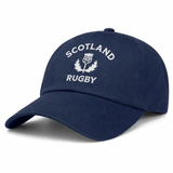 The EMB S&S Activewear Nations of Rugby Scotland Dad Cap features "Scotland Rugby" and a thistle embroidered in white on navy blue cotton twill, giving it a classic dad cap style.