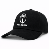 The Fiji Cotton Twill Dad Cap by EMB S&S Activewear features a black design with a white palm tree logo and embroidered "FIJI RUGBY" text on the front. Classic dad cap style, perfect for everyday wear.