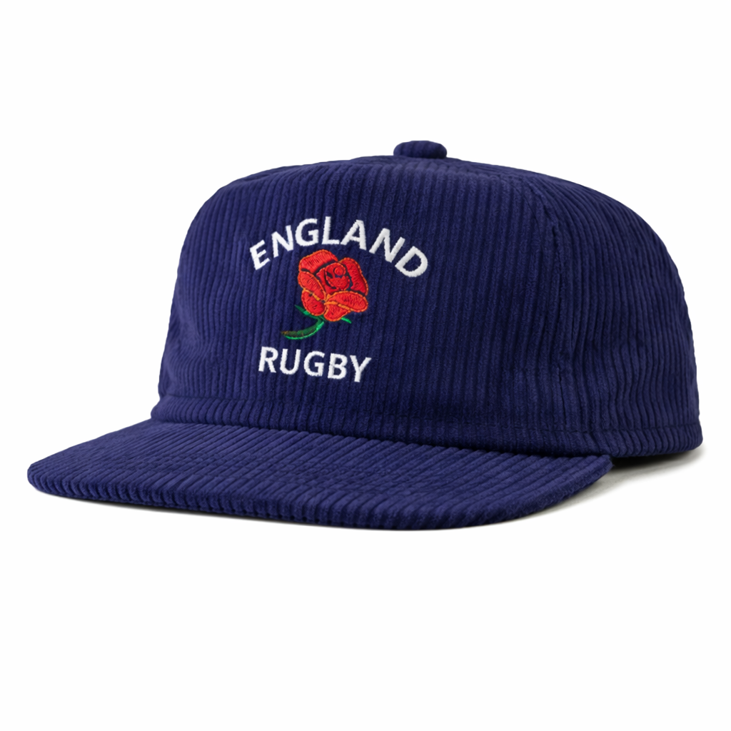 The EMB Weld Nations of Rugby England Corduroy Field Trip Cap is a navy corduroy hat with a curved brim, featuring "ENGLAND RUGBY" and a red rose embroidered on the front—a stylish tribute to rugby heritage.