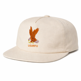 The EMB Weld USA Rugby Alternate Heritage Brushed Cotton Cap features a beige design with a flying eagle holding a branch above "USARFU" on the front, inspired by the classic USA Rugby Heritage Cap style.