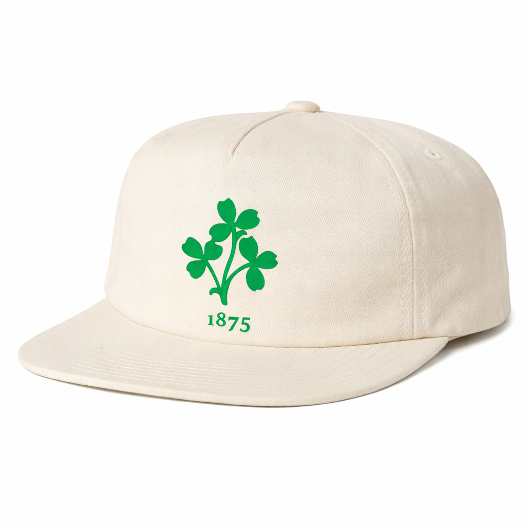 The EMB Weld Nations of Rugby Ireland Vintage Brushed Cotton Cap features a beige design with a green four-leaf clover and "1875" on the front, inspired by classic Irish rugby caps.
