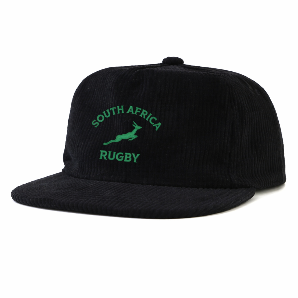 The EMB Weld Nations of Rugby South Africa Corduroy Field Trip Cap features black corduroy, embroidered green “South Africa Rugby” text, and a springbok logo—the perfect collectible cap for any rugby fan.