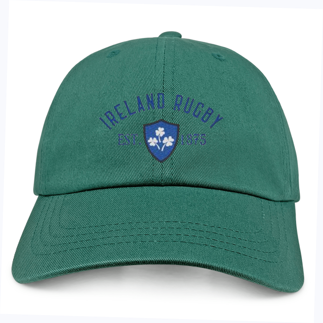 The Ireland Rugby 1875 Navy Logo Dad Cap by EMB S&S Activewear features "Ireland Rugby EST. 1875" and a blue shield with three shamrocks—an ideal accessory for any rugby fan.