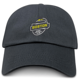 A dark gray Boston RFC Adult Low-Profile Cotton Twill Dad Cap with the logo of the Boston Rugby Football Club embroidered in yellow, black, and white on the front.
