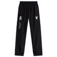 The De La Salle Cuffed Hem Stadium Pant by EMB Canterbury features a black design with white logos, including "Canterbury of New Zealand" and "De La Salle Rugby." These pants include an elastic waistband and straight legs, providing exceptional comfort.