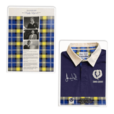 A display showcases the Ellis Rugby Doddie Weir Classic Jersey, featuring a blue design with a white collar, embroidered elements, and signatures. It boasts a Scotland crest. Beside it is a panel with black and white photos, text, and accents of blue and yellow plaid tartan trim.