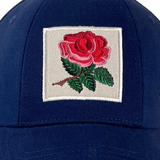 The Ellis Rugby England Rugby 1991 Six Nations Cap by Ellis Rugby, made of organic cotton in Navy blue, showcases an embroidered red rose with green leaves on a white square. It's ideal for Six Nations enthusiasts and echoes the classic England Rugby 1991 style.