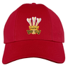 The Ellis Rugby Wales Rugby 1976 Triple Crown Cap showcases an embroidered design with three white feathers and "ICH DIEN" on the front, celebrating a Grand Slam triumph.