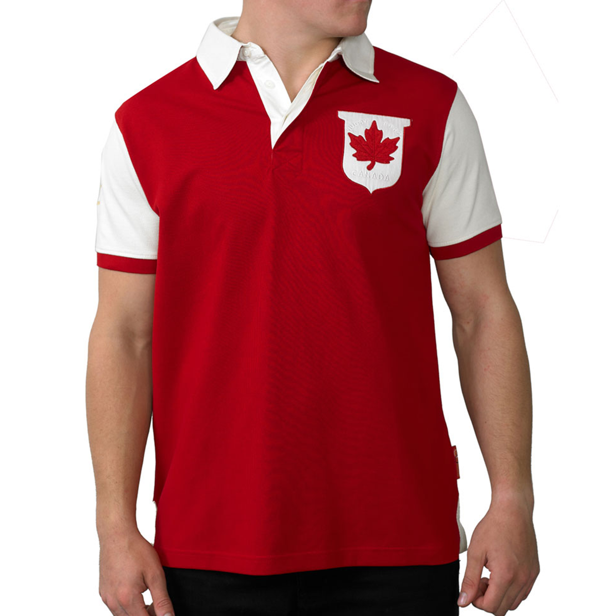 A man wears an Ellis Rugby Canada Rugby Polo, characterized by red color, white sleeves, and collar. It features a classic Canadian crest with a maple leaf emblem on the chest.
