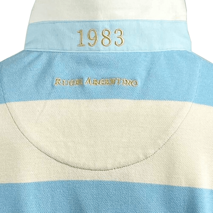 Close-up of the Ellis Rugby Argentina Rugby Polo made from 100% cotton, showcasing "1983" at the top with "Rugby Argentino" below in light blue and off-white, reflecting the Ellis Rugby heritage.