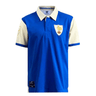 The Ellis Rugby France Rugby Polo 1959 by Ellis Rugby is a stylish blue and white two-tone cotton pique polo shirt with a white collar. It features two embroidered shields on the left chest and left sleeve, along with a black tag near the bottom. This polo is perfect for fans of the Five Nations Rugby Tournament.
