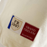 Close-up of a label on the Ellis Rugby 21 Club Collection 1997 France Polo Shirt reading "FR 1997 Grand Chelem Ellis Rugby" with a design of the French flag.