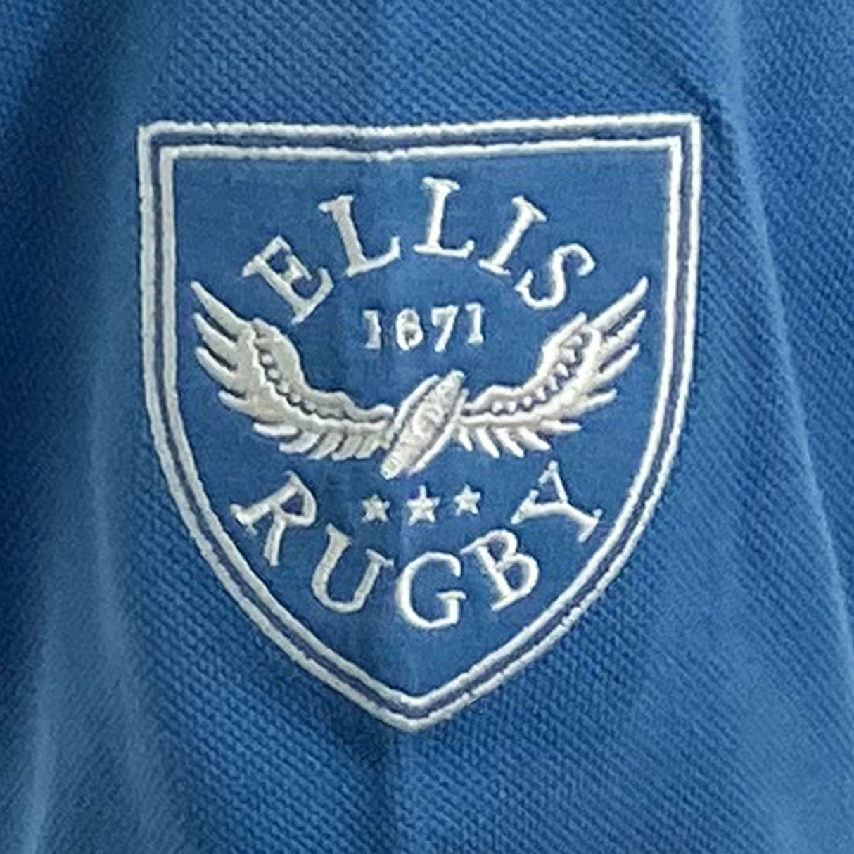 The Northern Transvaal Bulls Vintage Polo by Ellis Rugby features blue fabric with the iconic white "Ellis Rugby 1871" shield logo adorned with wings and stars, capturing a timeless sporting spirit.