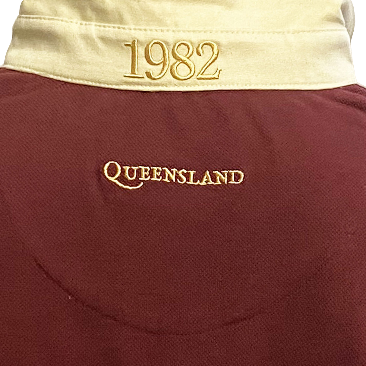 Close-up of the Ellis Rugby's Queensland 1982 Vintage Rugby League Polo in maroon and beige, featuring "1982" and "Queensland" embroidered in gold on the back, celebrating Queensland Rugby League history.