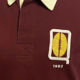 The Ellis Rugby Queensland 1982 Vintage Rugby League Polo highlights a maroon shirt with a beige collar featuring an embroidered yellow football and "1982," celebrating Queensland Rugby League's State of Origin era.