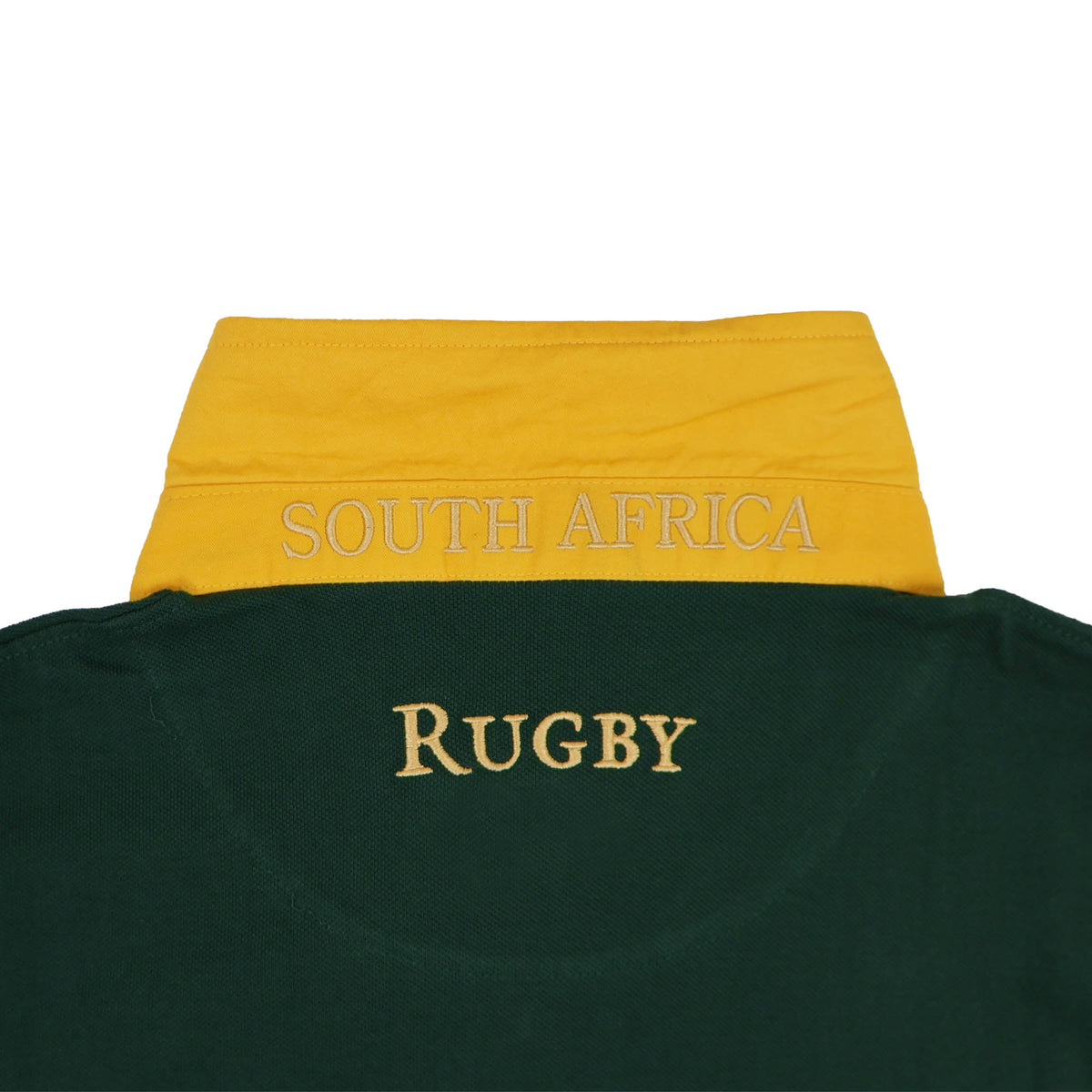 Show your support for the Springboks with the South Africa Rugby Polo 1924 by Ellis Rugby. This green polo shirt features “RUGBY” embroidered across the back, a vibrant yellow collar adorned with “SOUTH AFRICA” stitched in white, and classic Ellis Rugby styling—making it an ideal choice for any fan of South Africa rugby.