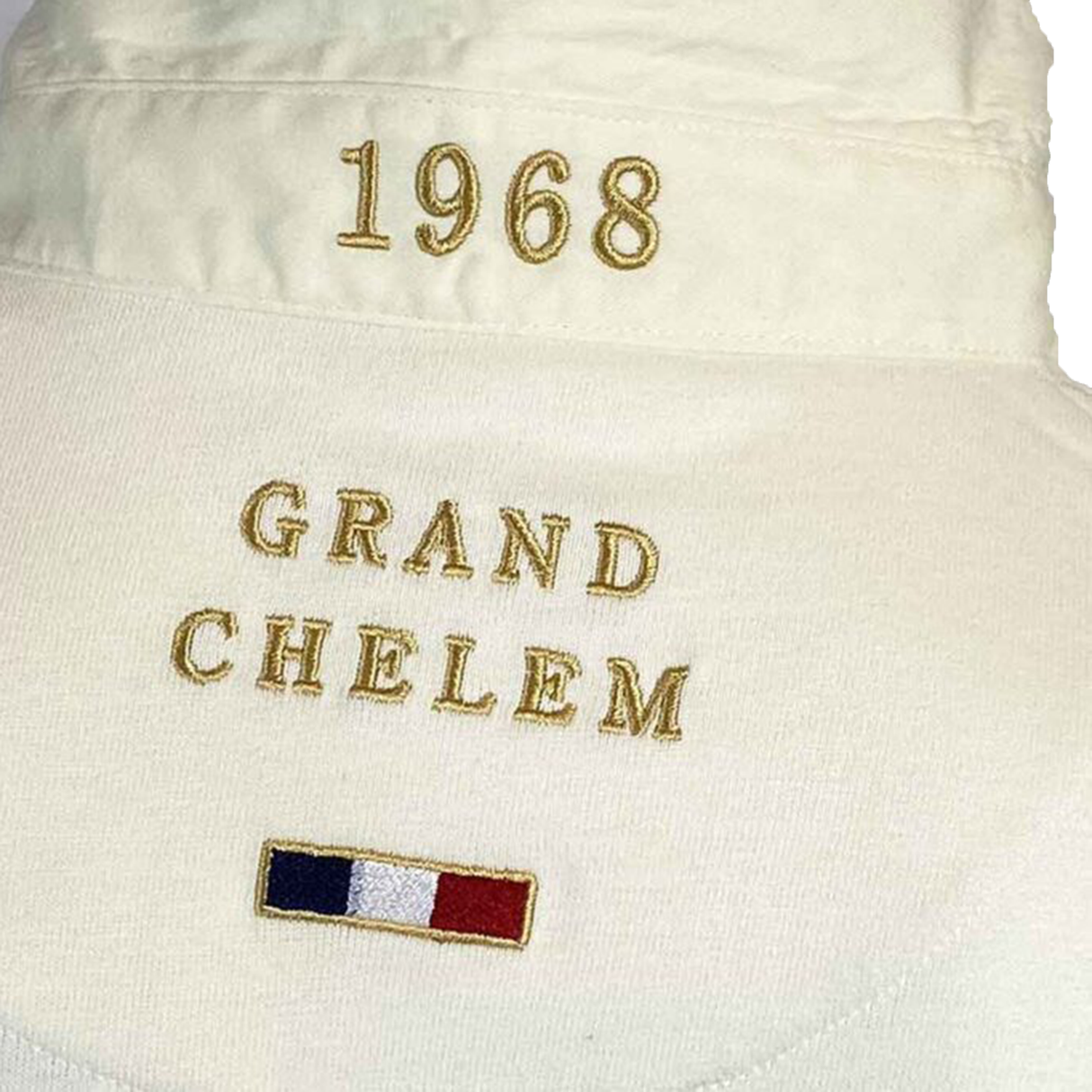 Close-up of the Ellis Rugby France 1968 Grand Slam Classic Rugby Shirt fabric, featuring embroidered "1968" and "GRAND CHELEM" above a small French flag, celebrating France's historic 1968 Grand Slam victory.