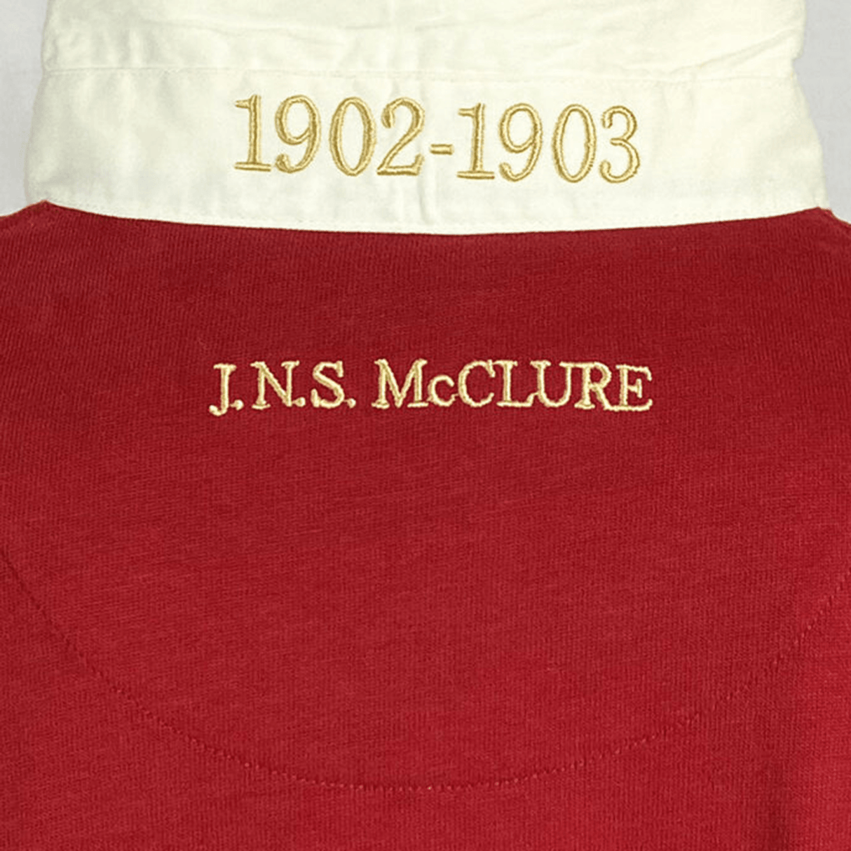 The back of a red shirt with the name Jns McCure on it, featuring Ellis Rugby 21 Club Collection 1902 Canada Rugger.