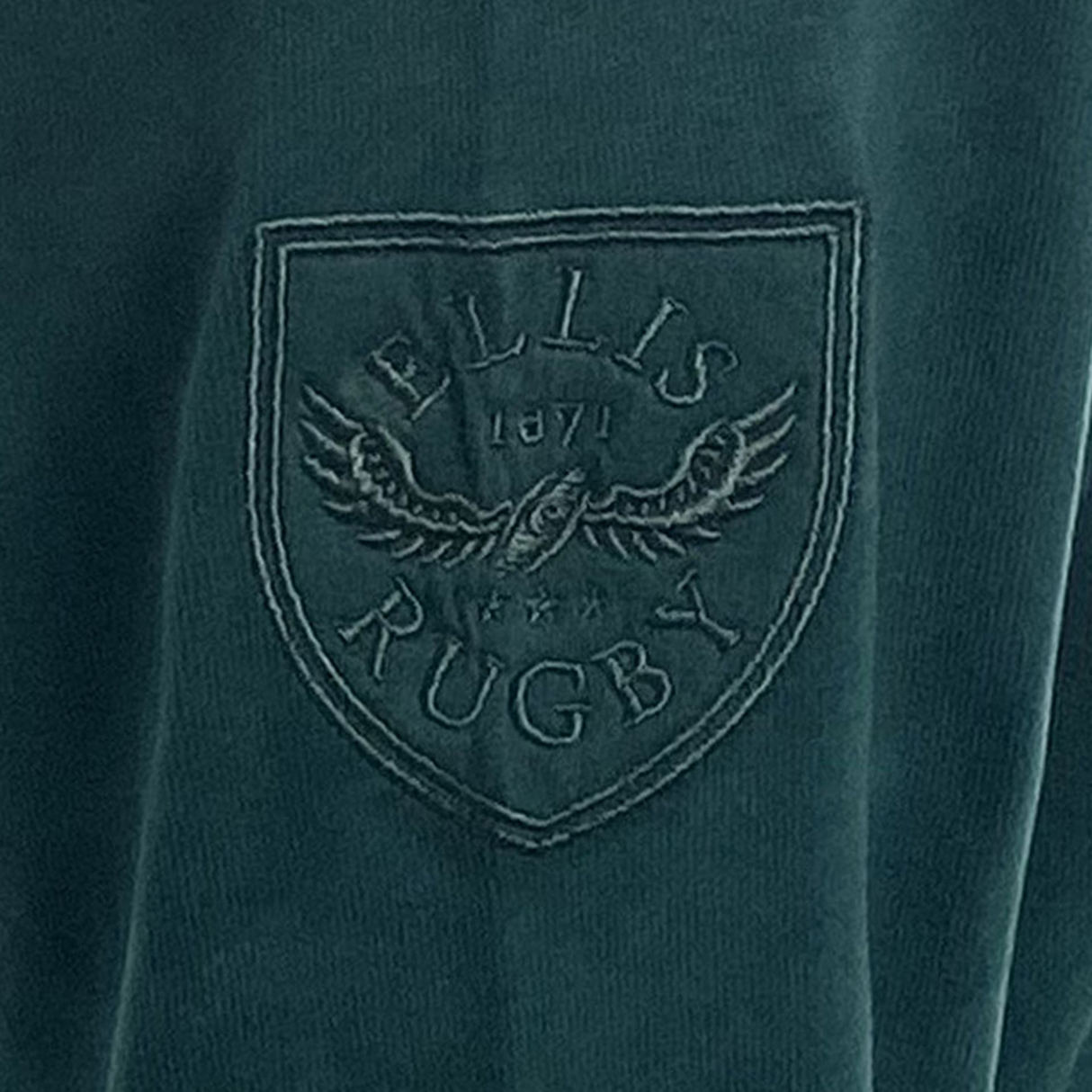 The Ellis Rugby Springbok 1995 Vintage Long Sleeve Rugby Shirt features an embroidered fabric patch with "Ellis Rugby," "1871," and a winged emblem, celebrating South Africa's rugby heritage reminiscent of the iconic 1995 Springboks.