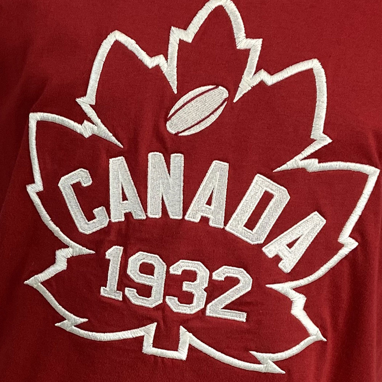 The Canada Rugby 1932 T-Shirt by Ellis Rugby features a red color with a white embroidered maple leaf design, the word "CANADA," and the year "1932," celebrating Canada's rugby heritage and national pride.