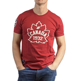 The person is wearing a Canada Rugby 1932 T-Shirt by Ellis Rugby, which is red with a white maple leaf and "Canada Rugby" text, paired perfectly with blue jeans.