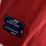 Close-up of a red shirt featuring the inscription "Canada Rugby 1932 by Ellis Rugby," evoking Canada's rich rugby history.