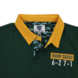 Dark green Bomb Squad Rugby Polo by Ellis Rugby featuring a yellow collar, a camouflage inner lining, and a chest patch reading “BOMB SQUAD 6-27-1”.