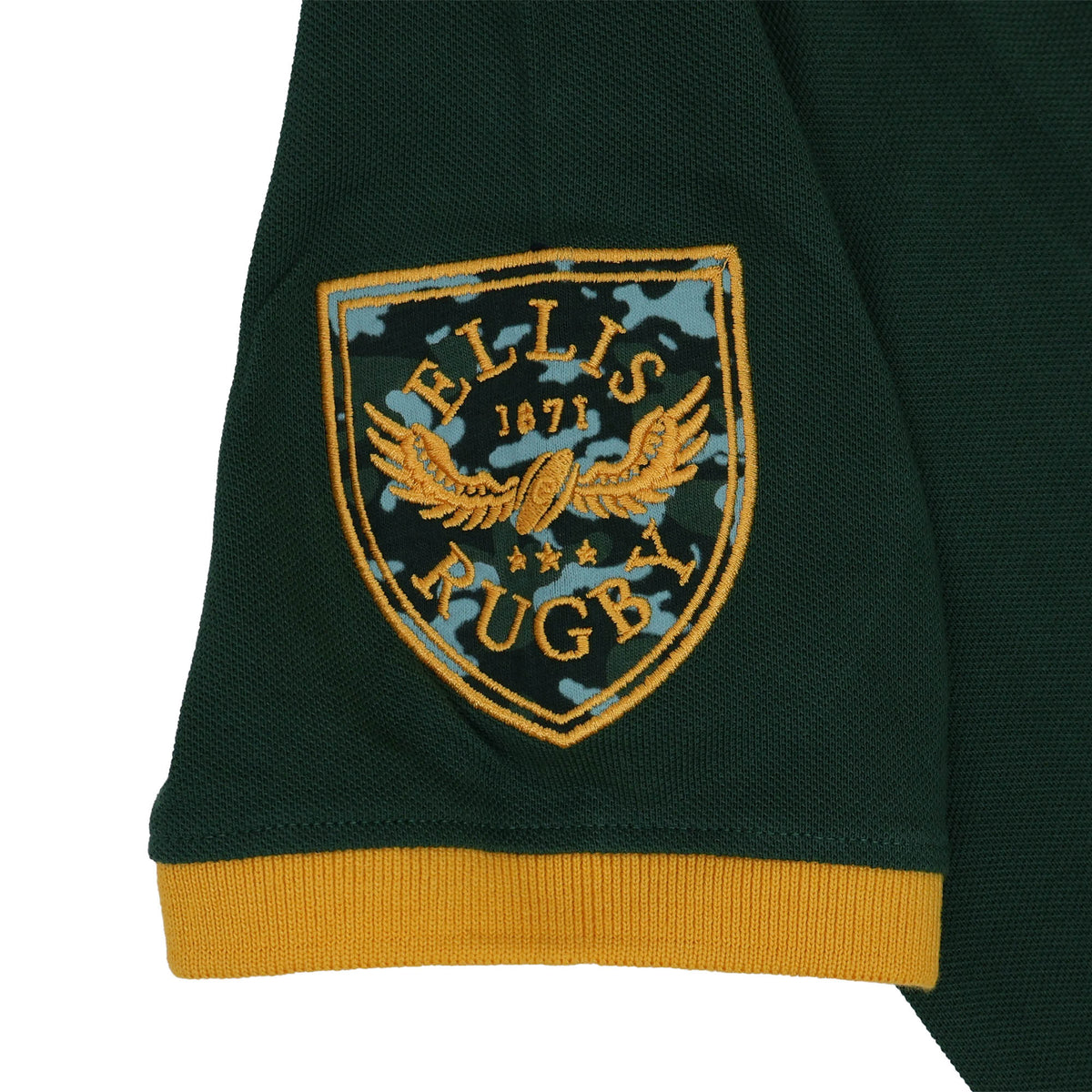 Embroidered Ellis Rugby crest with a camouflage pattern on a dark green Bomb Squad Rugby Polo sleeve with a mustard yellow cuff.