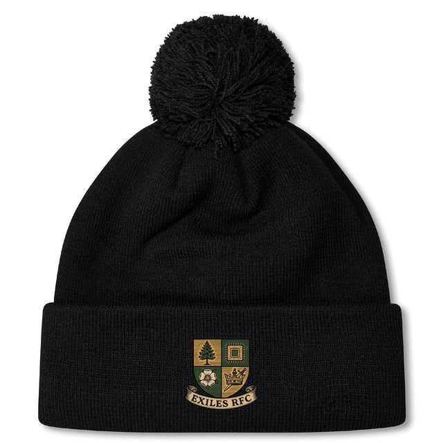 The Exiles Rugby Football Club Pom Pom Beanie by EMB Canterbury is a black, fleece-lined hat with a pom-pom and the Exiles RFC crest embroidered on the front cuff for added warmth and style.