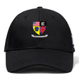 The Erie Rugby Club Flexfit Drill Cap by Canterbury features a black curved brim, crest with American & British flags, yellow & blue emblem, black & white “E,” “ERIE RUGBY CLUB” banner, and premium Flexfit comfort by EMB Canterbury.