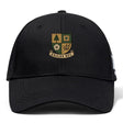 The Exiles Rugby Football Club Flexfit Drill Cap by Canterbury features the Exiles RFC crest with four symbols and a scroll on the front and an embroidered logo, all in black. Brand: EMB Canterbury.