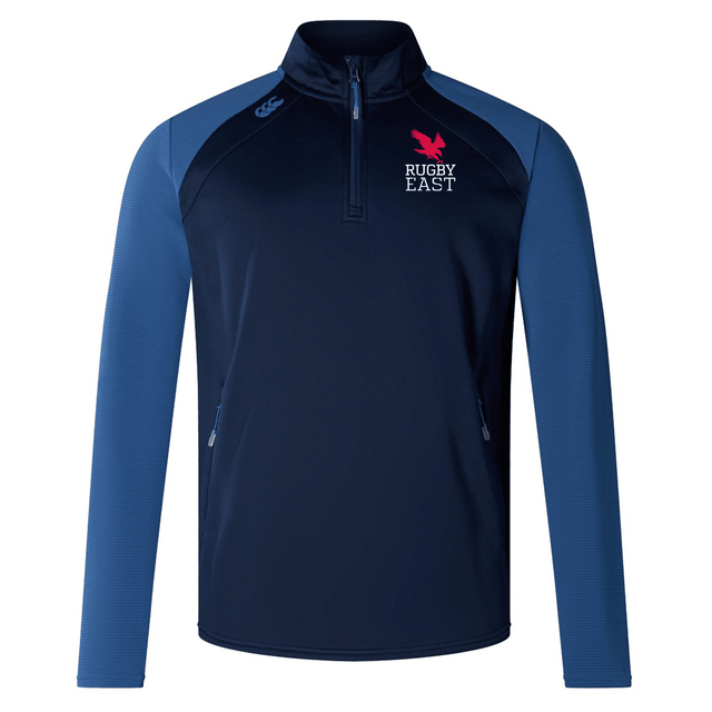 A blue long-sleeve rugby jacket with a half-zip front. This comfortable fabric Rugby East Conference Elite 1/4 Zip Top by Canterbury features the "Rugby East" logo with a pink lion on the chest and a small blue EMB Canterbury logo on the right shoulder, perfect for training wear.