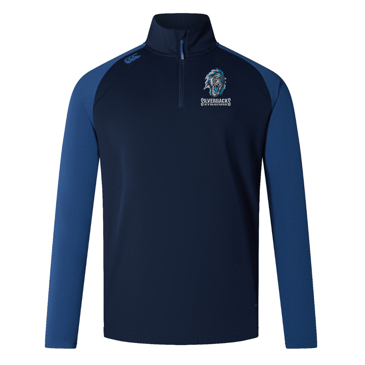 A navy blue and dark blue long-sleeve sports jacket with a half-zip, featuring the Silverbacks Rugby logo on the left chest. This Syracuse Silverbacks Elite First Layer by Canterbury integrates VapoDri technology for optimal comfort during rugby training sessions by EMB Canterbury.