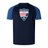 A navy-blue Cincinnati Rookie Rugby Elite Training Tee by Canterbury with blue sleeves, featuring the "Rookie Rugby Cincinnati" logo on the chest. Made from lightweight and durable Vapodri fabrics, it's perfect for both training and casual wear.