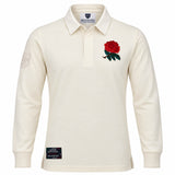 The Ellis Rugby England Rugby 1991 Shirt 1992 Grand Slam features cream long sleeves, a red rose emblem on the left chest, a patch on the left sleeve, and a black label above the hem. Inspired by England’s iconic 1992 Grand Slam victory, this shirt pays tribute to classic rugby heritage.