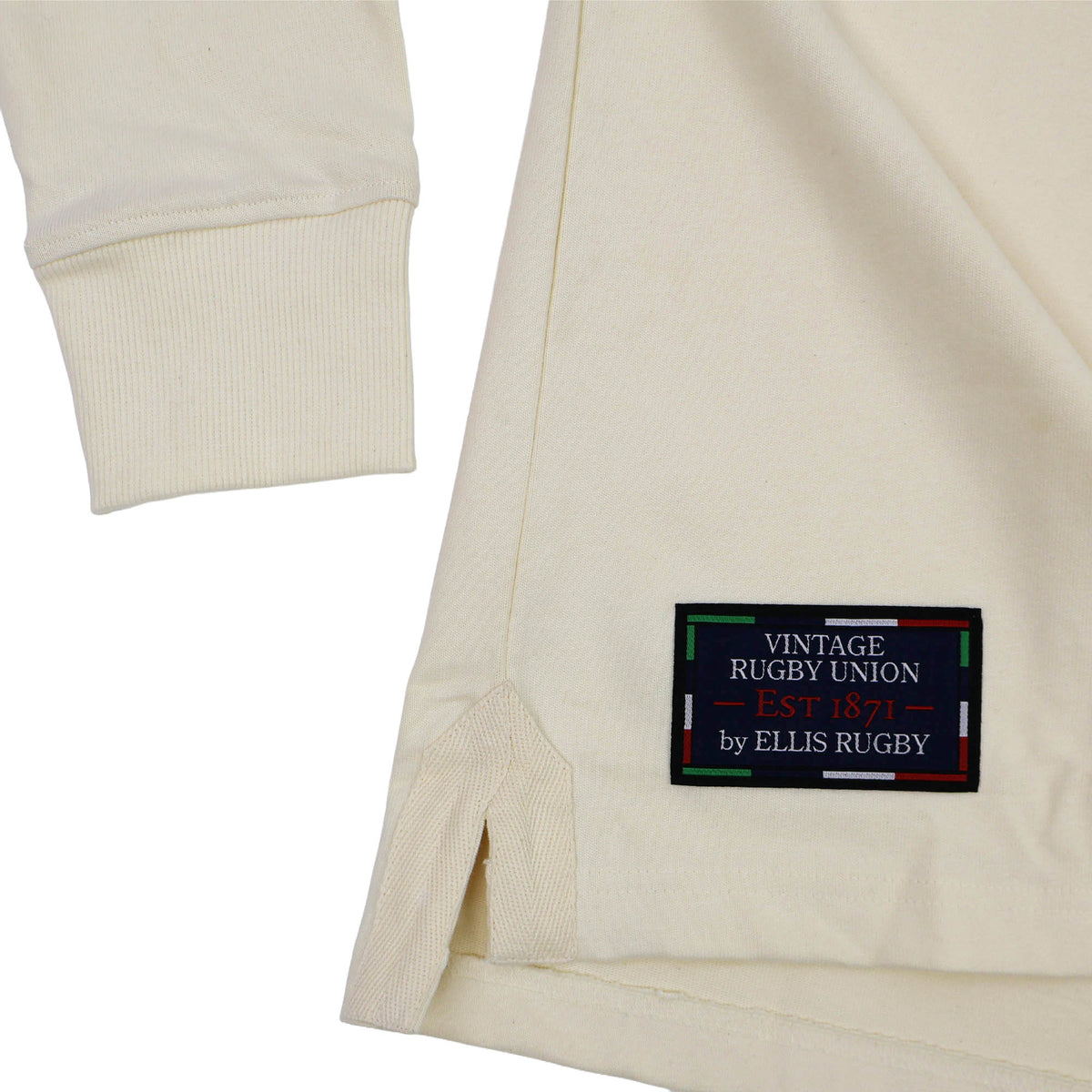 Close-up of a cream long-sleeve shirt with a black patch reading “Vintage Rugby Union EST 1871 by Ellis Rugby” sewn near the hem, inspired by the England Rugby 1991 Shirt 1992 Grand Slam by Ellis Rugby—a subtle nod to classic rugby style and Grand Slam heritage.
