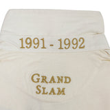 Close-up of the England Rugby 1991 Shirt 1992 Grand Slam by Ellis Rugby’s white collar, featuring “1991 - 1992” and “GRAND SLAM” embroidered in gold thread—an iconic design from Ellis Rugby.