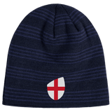 The England Shield Beanie by EMB Canterbury is a navy blue beanie with horizontal stripes, featuring an emblem of a red cross on a classic England shield.