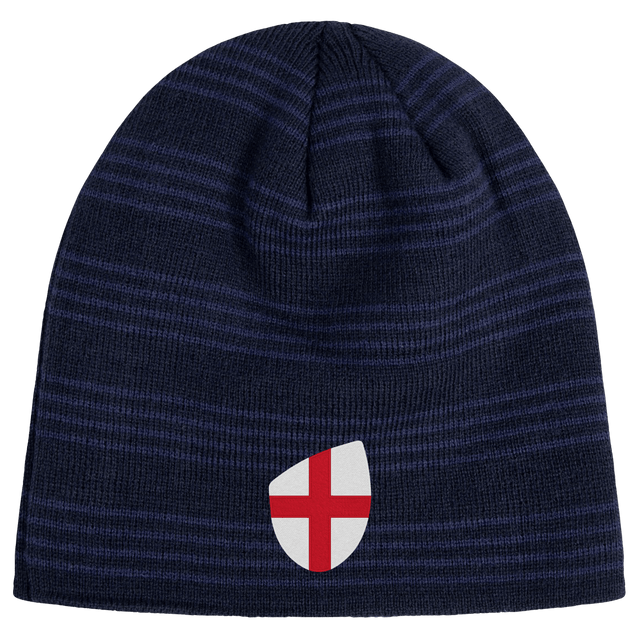The England Shield Beanie by EMB Canterbury is a navy blue beanie with horizontal stripes, featuring an emblem of a red cross on a classic England shield.