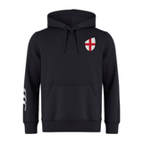 The England Shield Club Hoodie by EMB Canterbury is made from sweatshirt fleece and features a black design with a front pocket, the Canterbury branding, a red and white shield emblem on the chest, and a white stripe detail on the left sleeve.